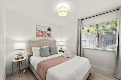 a bedroom with a large bed and a window at Recently Upgraded House with King Suite, quiet NBHD, Fast Wifi, and Yard in Elk Grove
