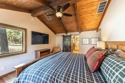a bedroom with a bed with a ceiling fan at Northstar Family Retreat on Shuttle Line with Deck in Truckee