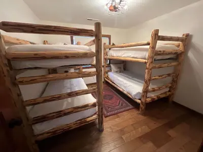 a room with two bunk beds in a room at Northstar Family Retreat on Shuttle Line with Deck in Truckee