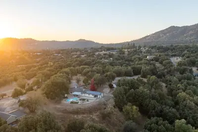 an aerial view of a house in the woods at Stunning views with pool, spa, gold panning, firepit, game court and BBQ in Ahwahnee
