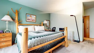 a bedroom with a bed and a desk with a lamp at Snowcreek IV #545 condo in Mammoth Lakes