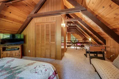 a bedroom with a bed and a desk in a room at Arnold Chalet Near Town and Calaveras Big Trees! in Arnold