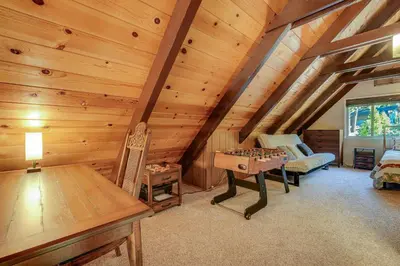 a room with a wooden attic with a table and chessboard at Arnold Chalet Near Town and Calaveras Big Trees! in Arnold