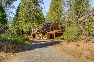 a house in the woods with a driveway at Arnold Chalet Near Town and Calaveras Big Trees! in Arnold
