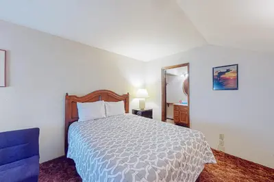 a bedroom with a bed and a blue chair at La Residence M9 in Mammoth Lakes