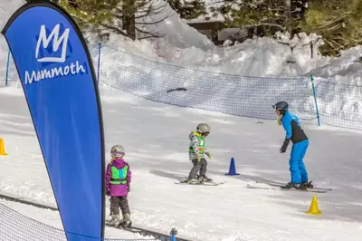 a group of people on skis in the snow at La Residence M9 in Mammoth Lakes