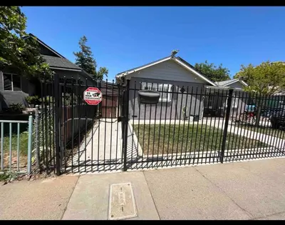 a gate with a stop sign in front of a house at Charming Casita all too yourself near Midtown, Train and Freeway in Sacramento