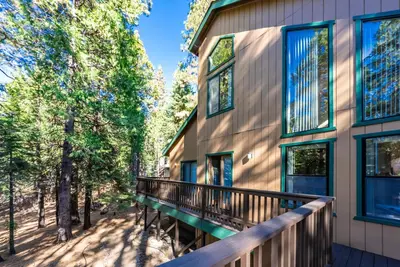 a balcony of a house with trees at Granite Ridge Getaway Chill Deck Vibes AC in Shaver Lake