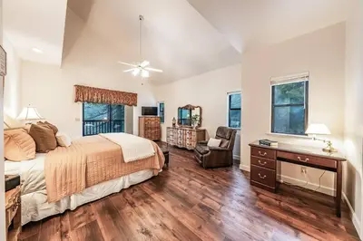 a bedroom with a bed and a desk and a chair at Granite Ridge Getaway Chill Deck Vibes AC in Shaver Lake
