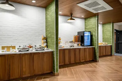 a restaurant with wooden counters and green walls at Fairfield Inn & Suites Livermore in Livermore