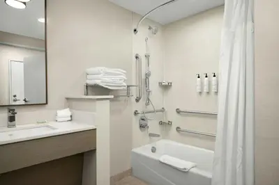 a bathroom with a tub and a sink and a shower at Fairfield Inn & Suites Livermore in Livermore