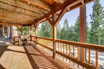 a porch of a cabin with a view of the woods at 6 Mi to Ski Slopes! Family Tahoe Cabin with 3 Decks in Tahoe Vista