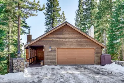 a house with a garage in the woods at 6 Mi to Ski Slopes! Family Tahoe Cabin with 3 Decks in Tahoe Vista