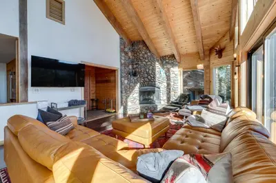 a living room with a large couch and a fireplace at 6 Mi to Ski Slopes! Family Tahoe Cabin with 3 Decks in Tahoe Vista