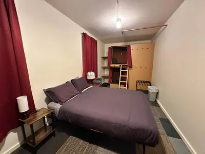 a bedroom with a large bed with purple sheets at West River House in Truckee