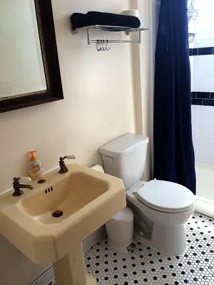 a bathroom with a white toilet and a sink at West River House in Truckee