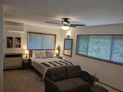 a bedroom with a bed and a couch and a ceiling fan at Bulldog Den in Twain Harte