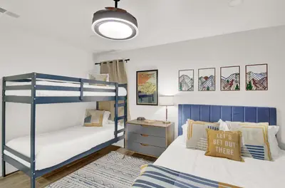 a bedroom with two bunk beds and a lamp at Yosemite Forest Villa in Oakhurst
