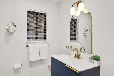 a bathroom with a sink and a mirror at Yosemite Forest Villa in Oakhurst