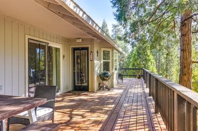 a porch of a house with a wooden deck at Forest-View Retreat Grill and Fireplace in Sonora in Sonora