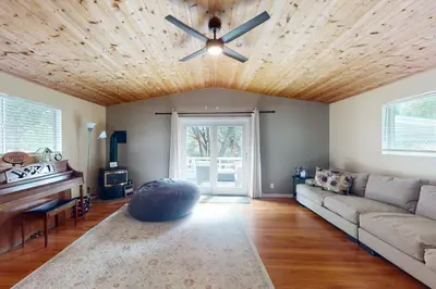 a living room with a couch and a ceiling fan at Uhre Family Retreat in Oakhurst