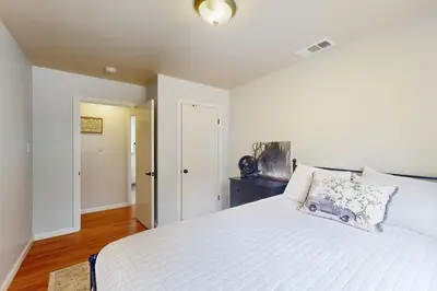 a bedroom with a large white bed and a door at Uhre Family Retreat in Oakhurst