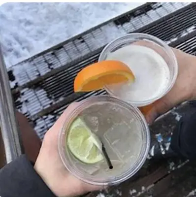a person holding a drink with an orange slice on it at Luxury 3 BDR Northstar Condo in Truckee