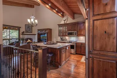 a kitchen with wooden cabinets and a large island at Luxury 3 BDR Northstar Condo in Truckee