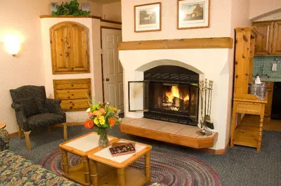 a living room with a fireplace and a couch at GetAways at Olympic Village Inn in Olympic Valley