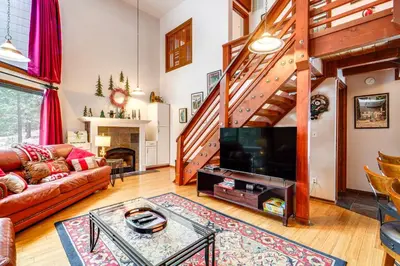 a living room with a couch and a tv at Shuttle to Slopes Northstar Gem with Hot Tub Access in Truckee