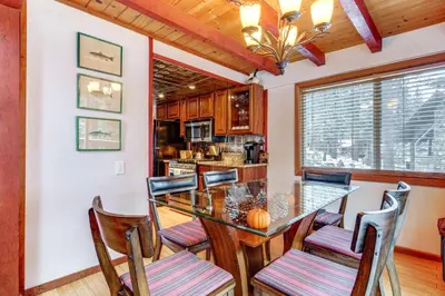 a kitchen with a dining room table and chairs at Shuttle to Slopes Northstar Gem with Hot Tub Access in Truckee