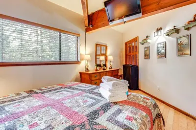 a bedroom with a bed and a tv on the wall at Shuttle to Slopes Northstar Gem with Hot Tub Access in Truckee