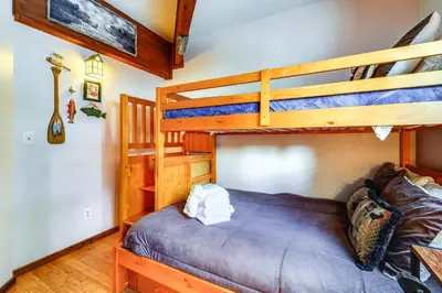 a bedroom with two bunk beds and a couch at Shuttle to Slopes Northstar Gem with Hot Tub Access in Truckee