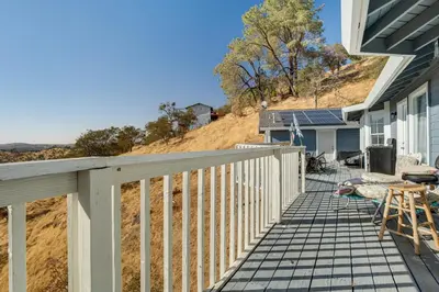 a porch of a house with a table and chairs at Water Views and Decks Spacious La Grange Retreat in La Grange