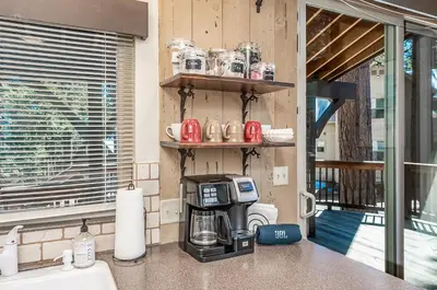 a kitchen with a coffee maker on a counter at Elderberry Bluejay Location Goals Tub Time in Shaver Lake