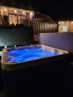 a hot tub with blue water in a room at Elderberry Bluejay Location Goals Tub Time in Shaver Lake