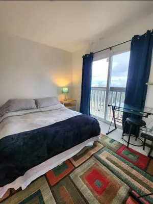 a bedroom with a bed and a large window at Majestic View in Mariposa