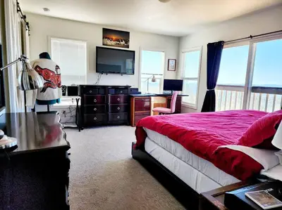 a bedroom with a bed and a desk and a television at Majestic View in Mariposa