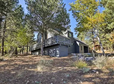 a small house in the middle of a forest at Dwell by Tahoe Getaways - 3BR Tahoe Donner w Sauna & HOA Amenities in Truckee