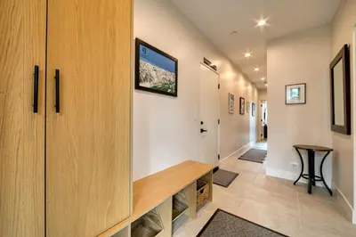 a hallway of a house with wooden cabinets and a table at Lightning Run at Palisades - 3 BR 3 BA Condo steps to Palisades Tahoe- Ski Shuttle in Olympic Valley