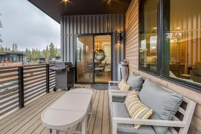 a porch with a bench and a table on a deck at Lightning Run at Palisades - 3 BR 3 BA Condo steps to Palisades Tahoe- Ski Shuttle in Olympic Valley