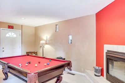 a room with a pool table and a fireplace at 7 Mi to Beach Home with Hot Tub in South Lake Tahoe in South Lake Tahoe