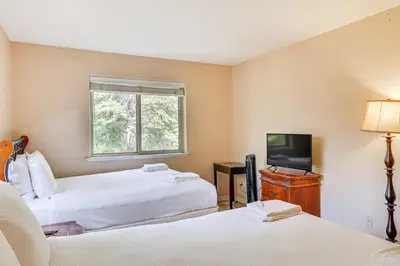 a hotel room with two beds and a television at 7 Mi to Beach Home with Hot Tub in South Lake Tahoe in South Lake Tahoe