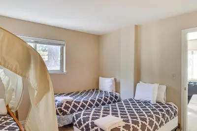 a room with two beds and a window at 7 Mi to Beach Home with Hot Tub in South Lake Tahoe in South Lake Tahoe