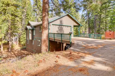 a house in the woods with a tree at 7 Mi to Beach Home with Hot Tub in South Lake Tahoe in South Lake Tahoe