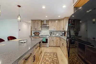 a large kitchen with wooden cabinets and a counter top at Nature Lovers' Retreat in South Lake Tahoe