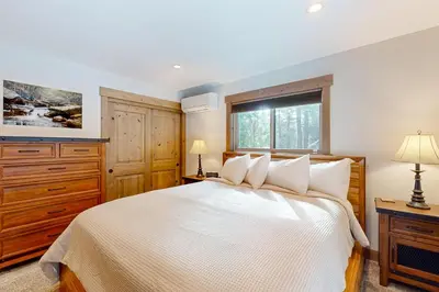 a bedroom with a white bed and a window at Nature Lovers' Retreat in South Lake Tahoe