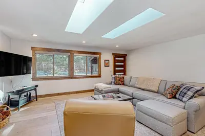 a living room with a couch and a flat screen tv at Nature Lovers' Retreat in South Lake Tahoe