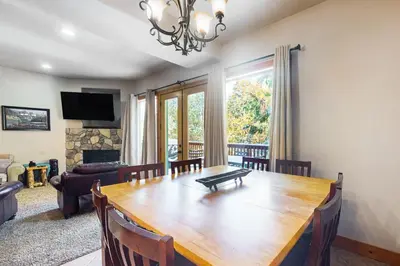 a dining room with a wooden table and a couch at Baby Bear Bliss in Shaver Lake