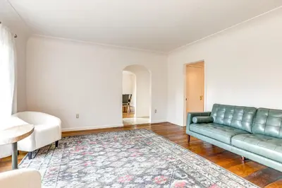 a living room with a green couch and a rug at 12 Mi to Folsom Historic District NorCal Getaway in Fair Oaks